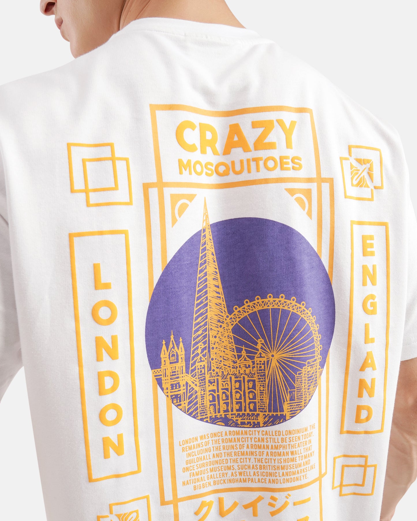 White t-shirt with yellow and purple graphics and text on a white background